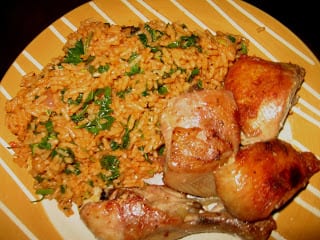 soft jollof rice with green vegetables and chicken